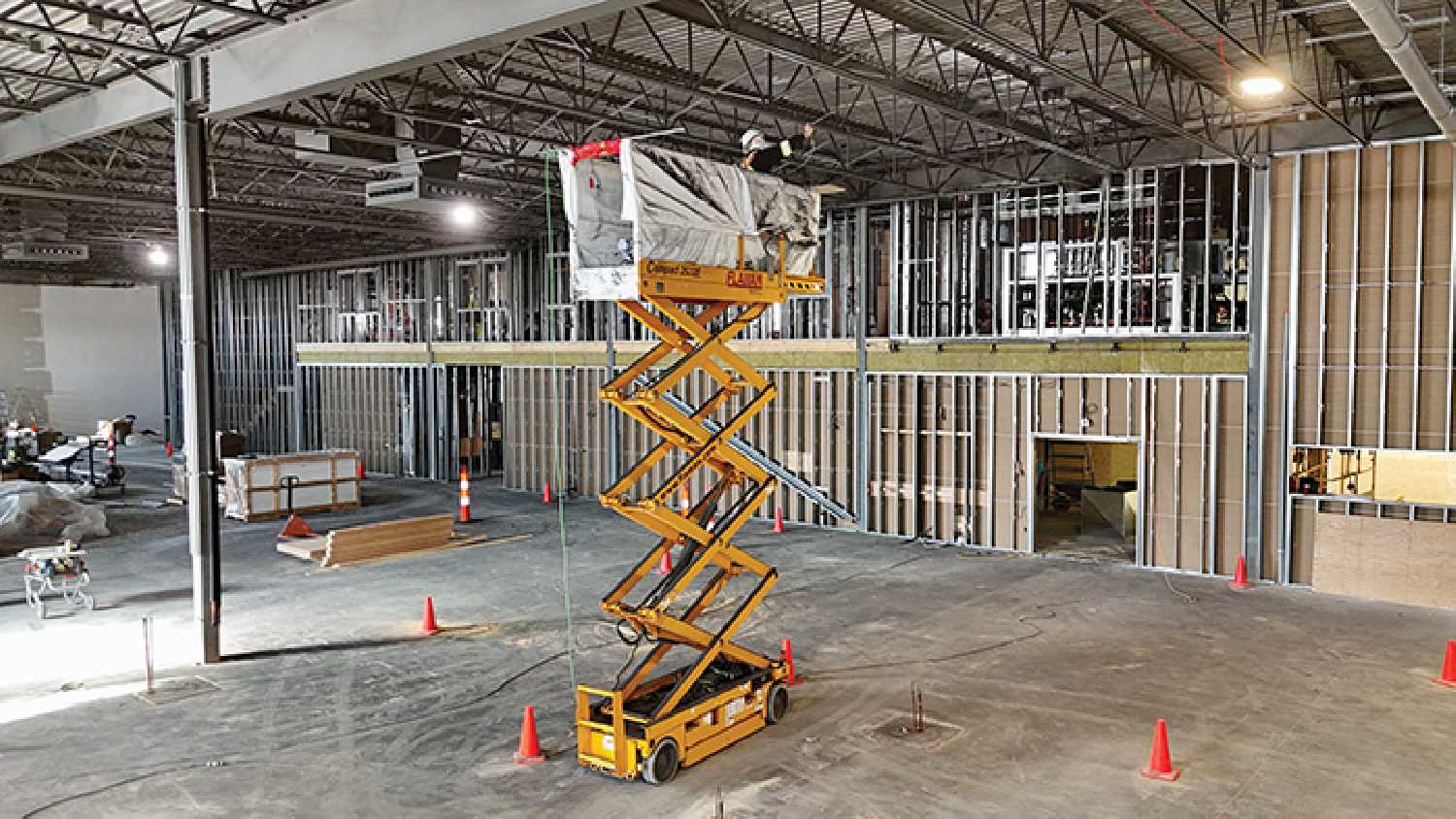 A worker paints the ceiling inside Borderland Co-ops new 30,000 square foot food store in Moosomin. The $18 million project will be complete next year.